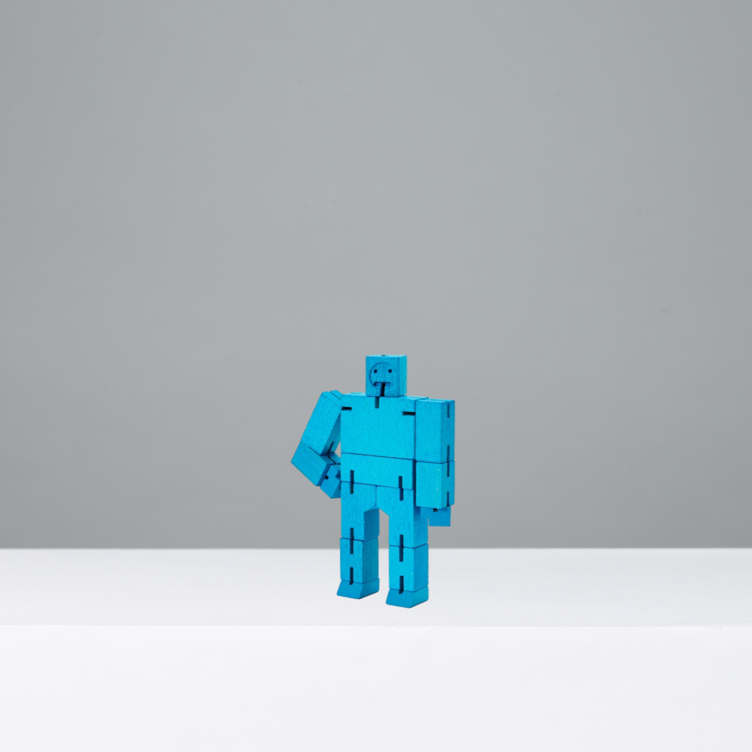 Blue robot figurine on a gray background