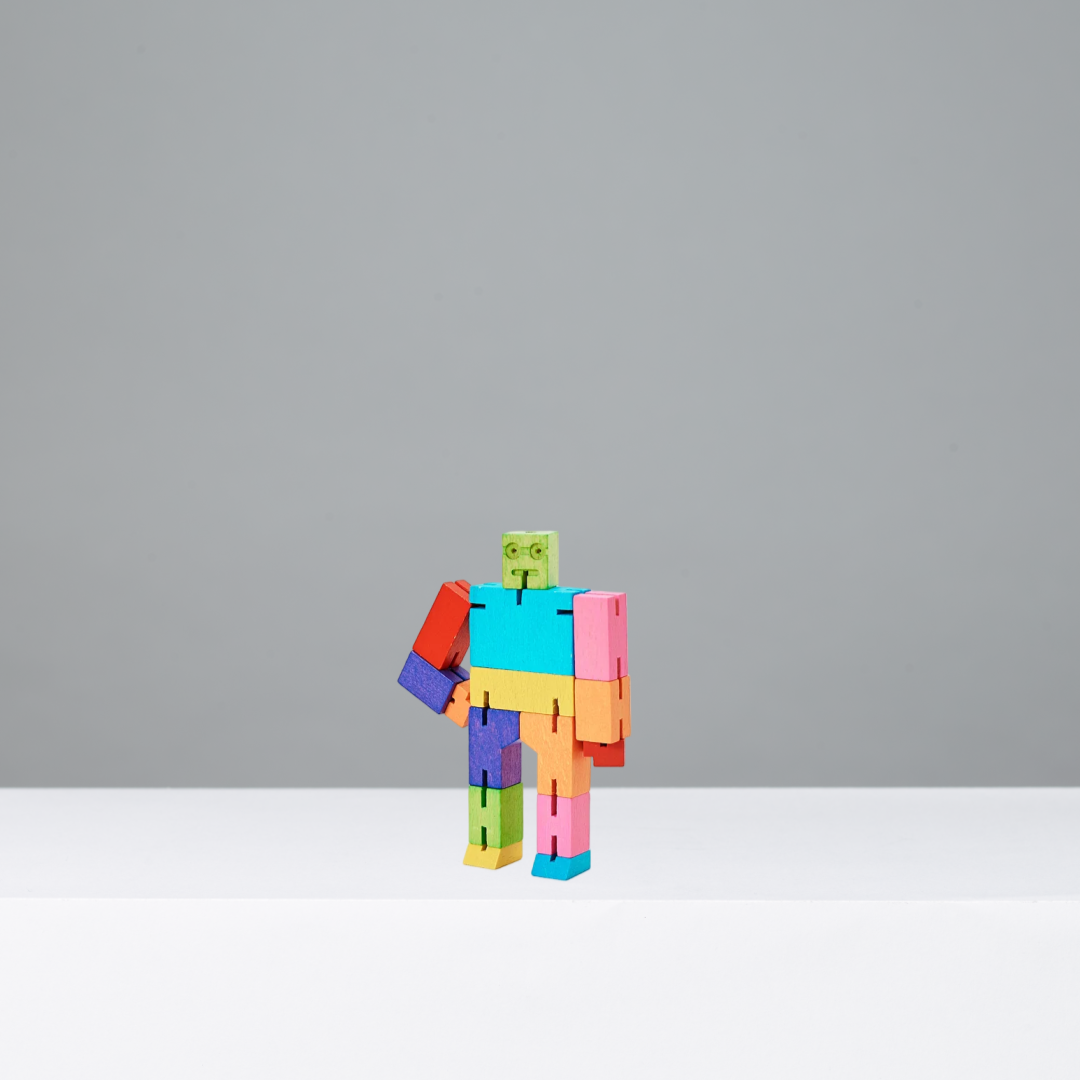 Colorful toy robot on a gray background