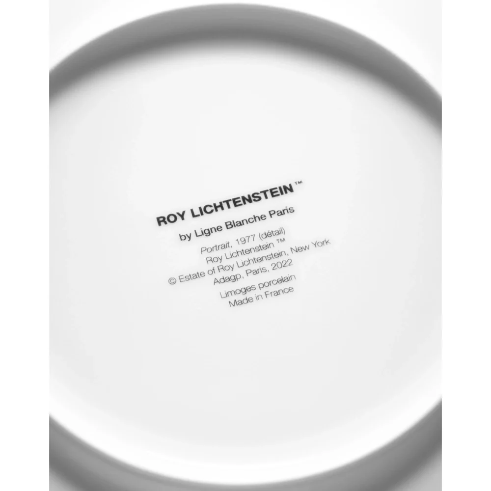 Close-up of a white plate with black text on a white background