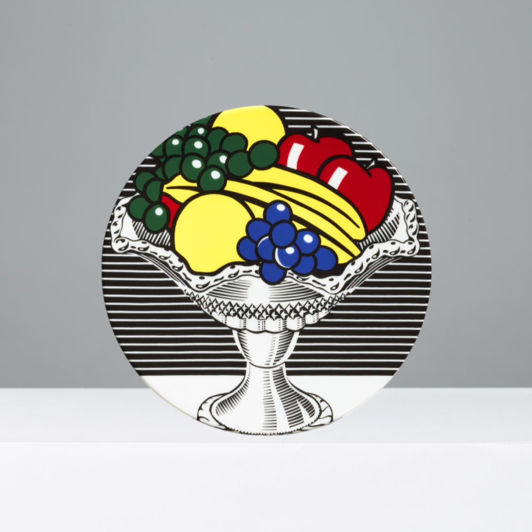 Decorative plate with colorful fruit design on a gray background