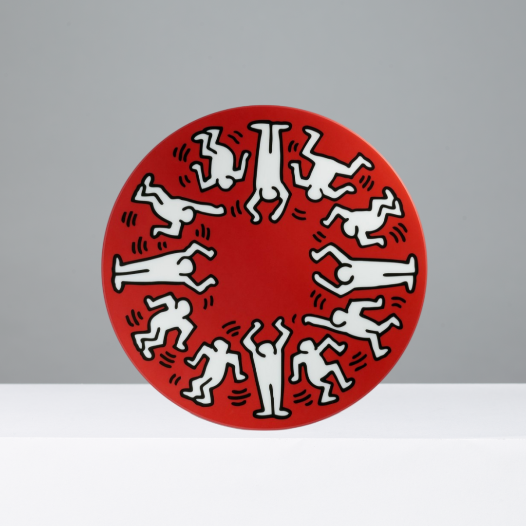Circular plate with white figures on a red background