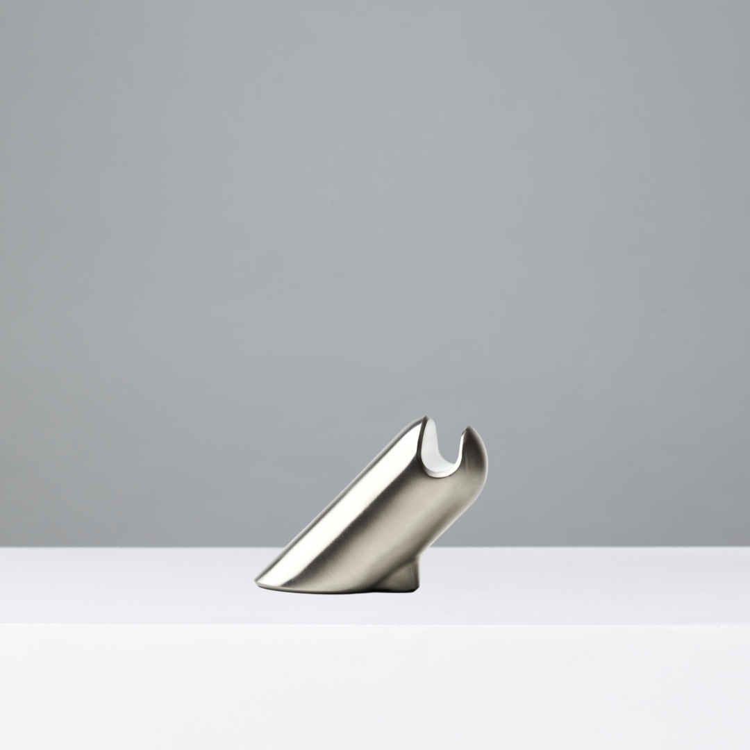 Stainless steel eyewear stand on a gray background