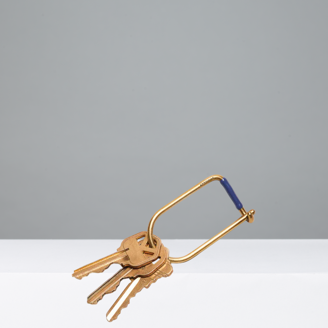 Gold keyring with keys on a gray background