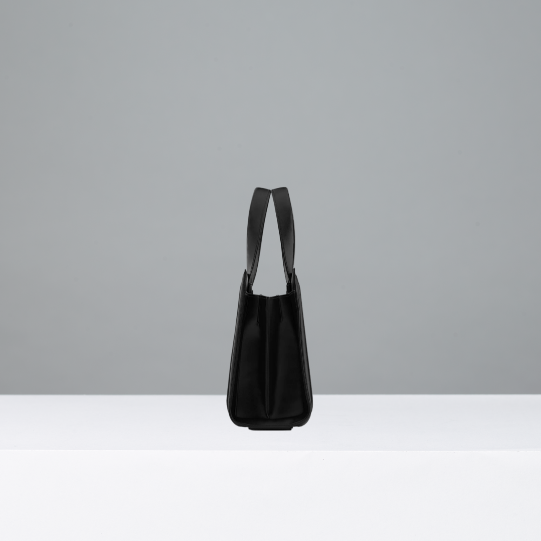 Black handbag on a gray background