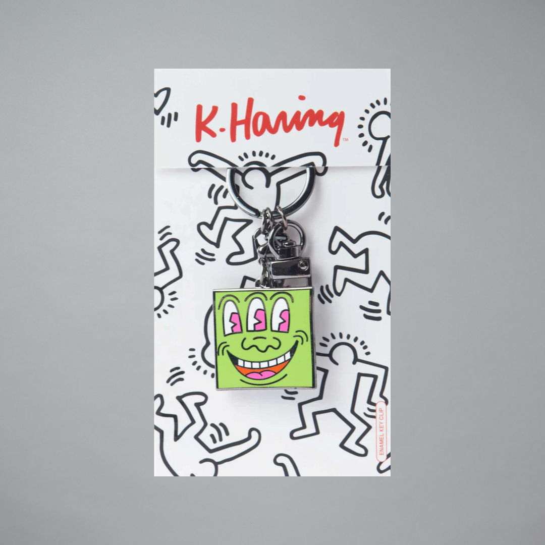 Keychain with a cartoon design on a branded card featuring 'K. Haring'.