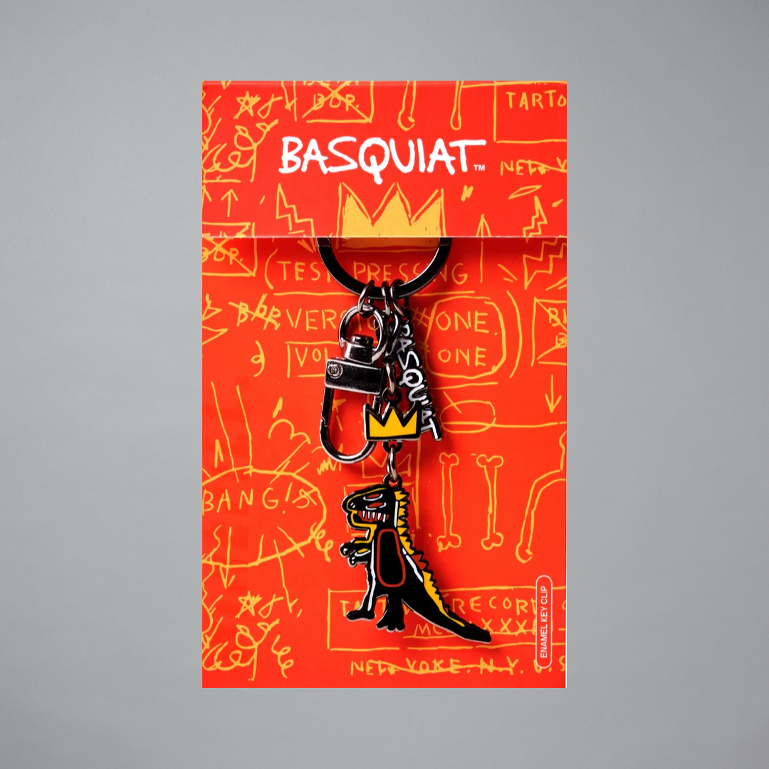 Jean-Michel Basquiat t-rex keychain with crown and 'BASQUIAT' branding on a red Basquiat-style packaging