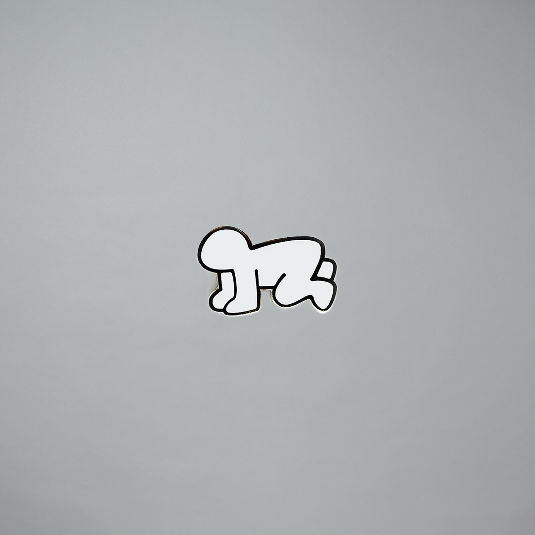 Keith Haring radiant baby pin in white on a gray background