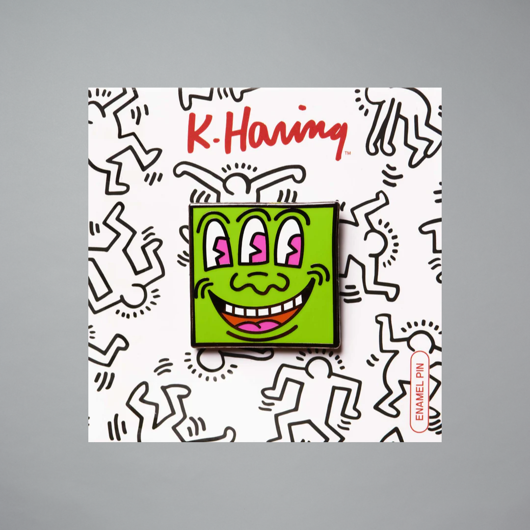 Keith Haring Three Eyed Monster pin on a gray background