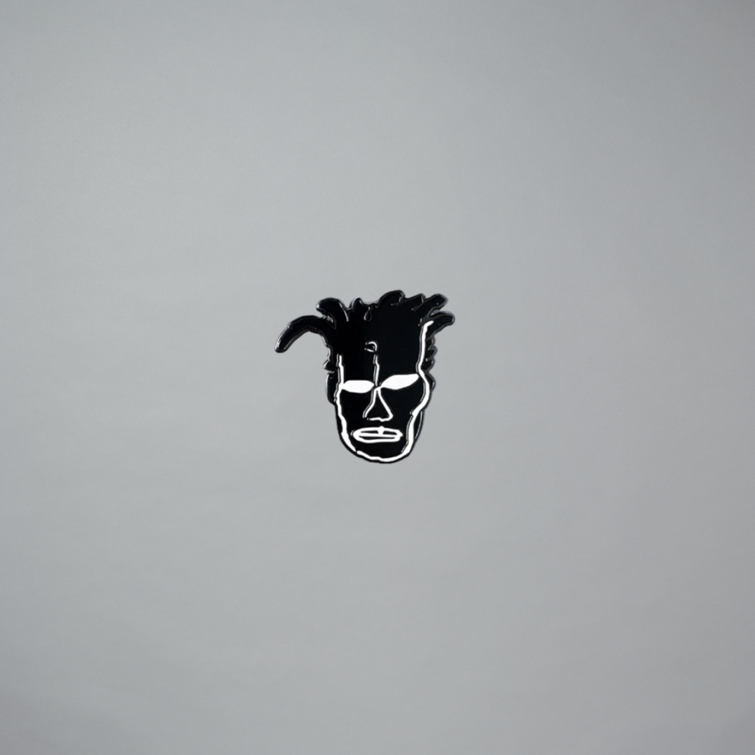 Jean-Michel Basquiat portrait pin on a gray background