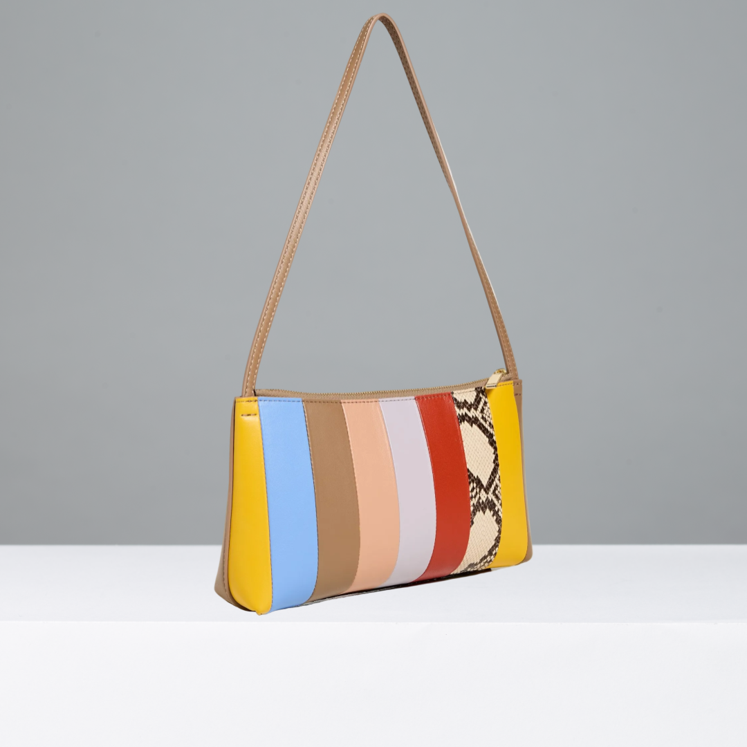 Multicolored striped handbag with a snake skin pattern on a gray background