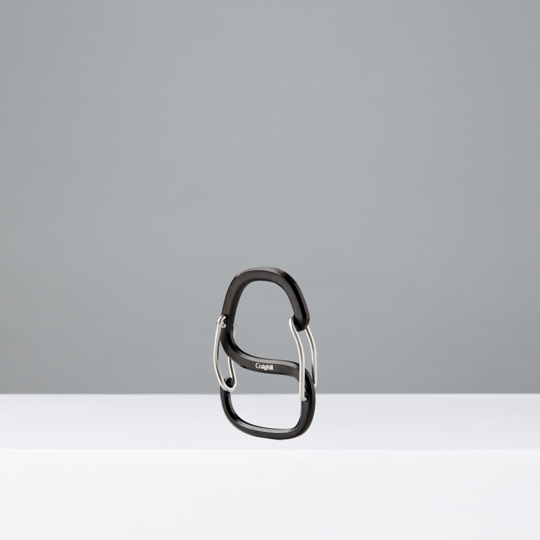 Black carabiner on a gray background