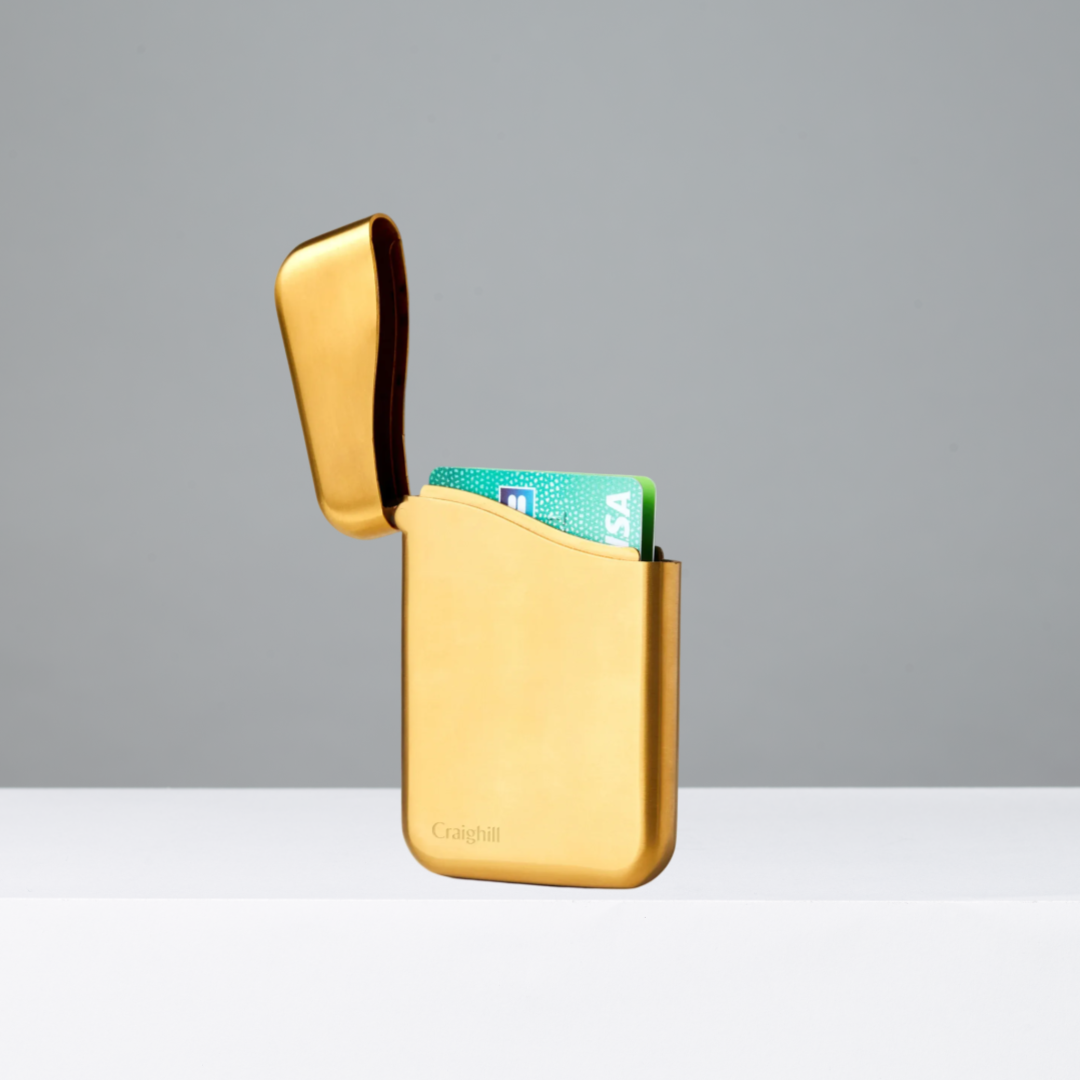 Vapor Brass Summit Card Case on a gray background
