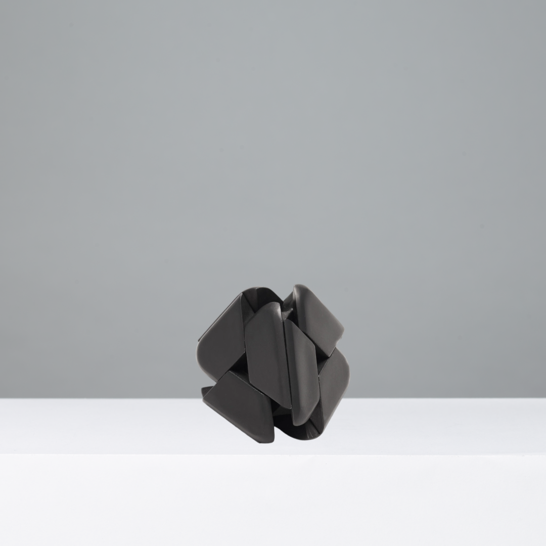 Black geometric puzzle on a gray background