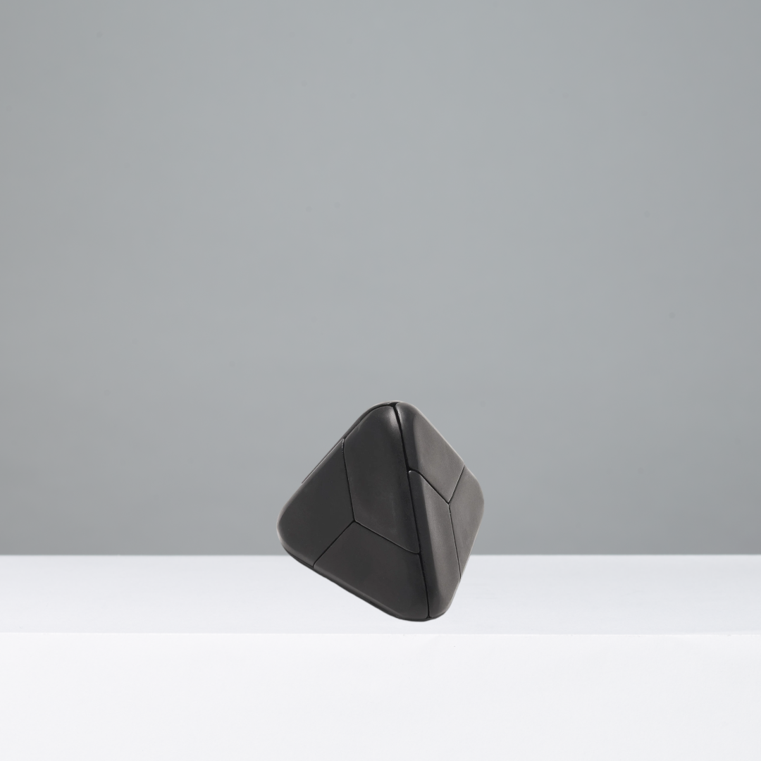 Black geometric puzzle on a gray background