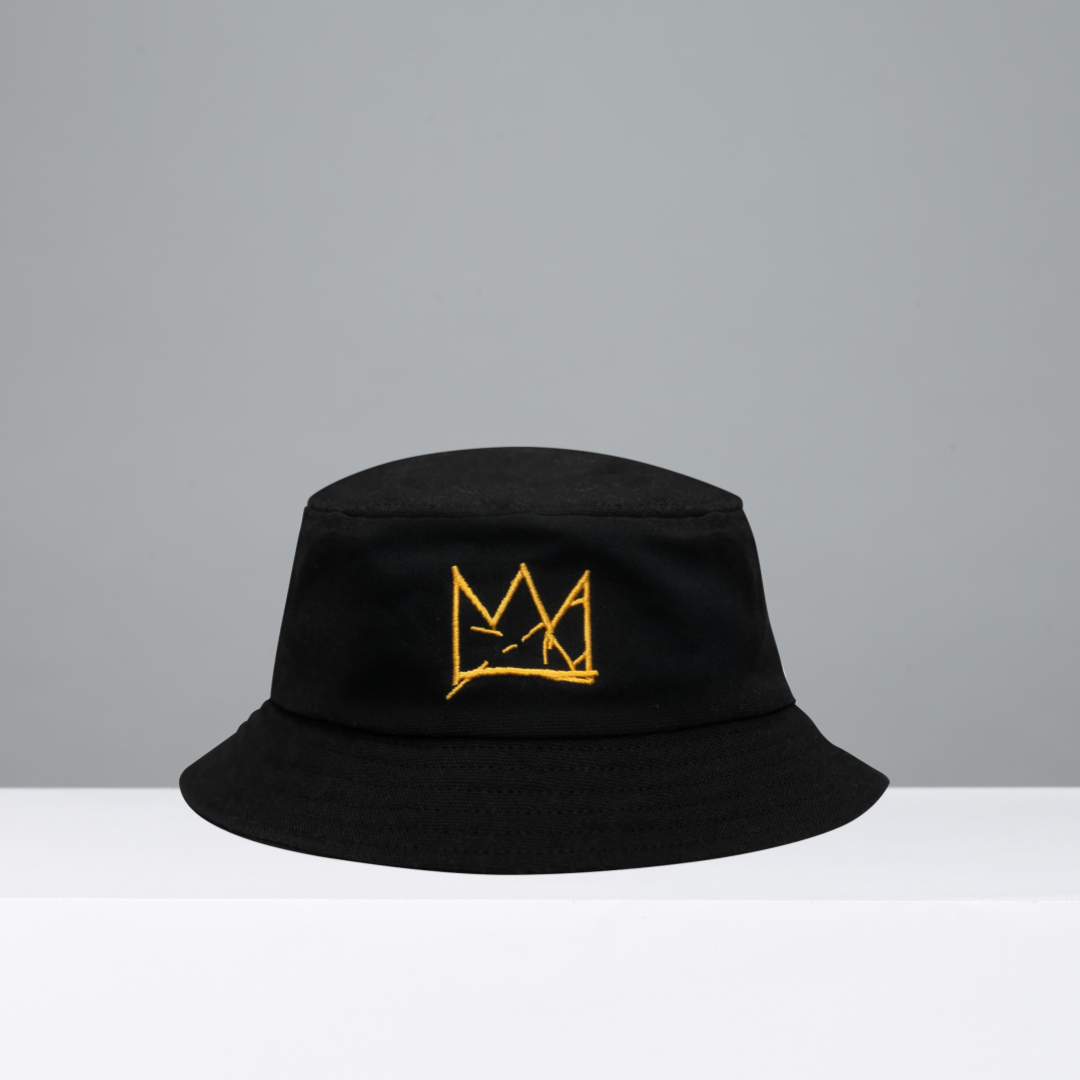 Black bucket hat with yellow crown logo on a gray background