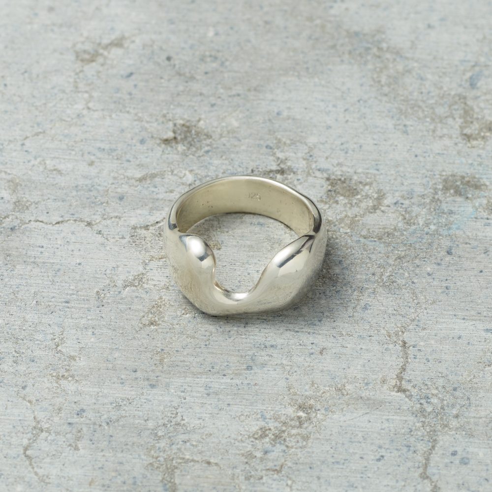 Silver ring on a textured gray surface