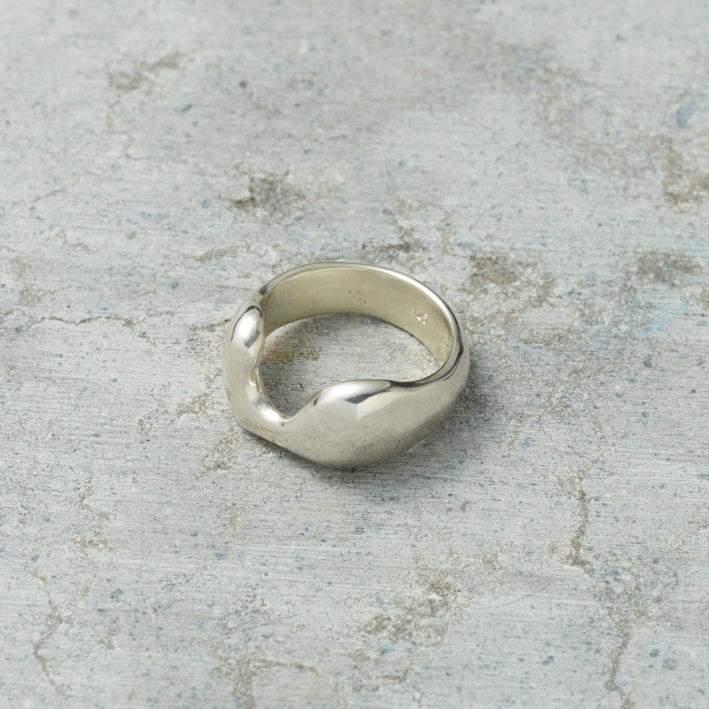 Silver ring on a textured gray surface