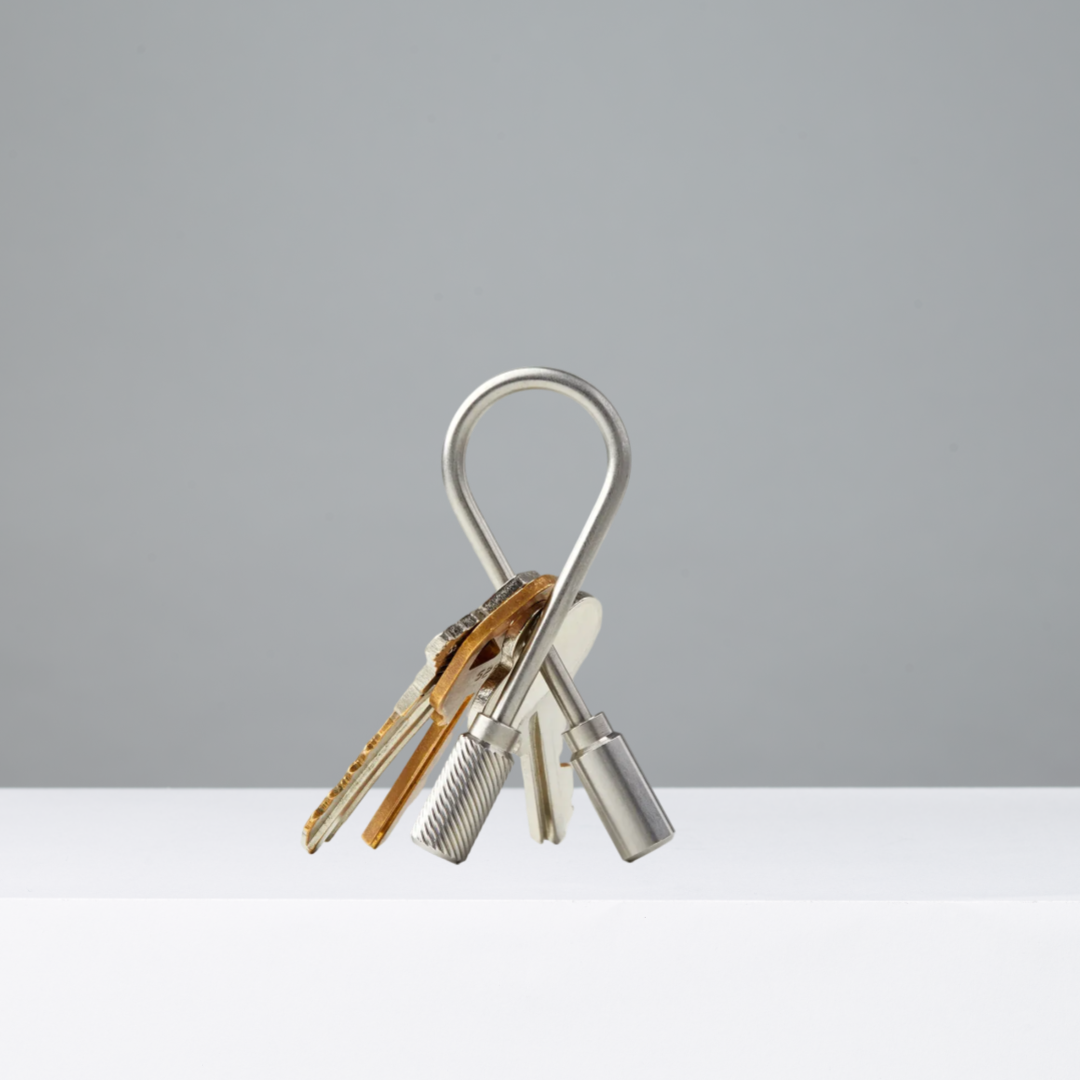 Stainless steel closed helix keyring with keys on a gray background