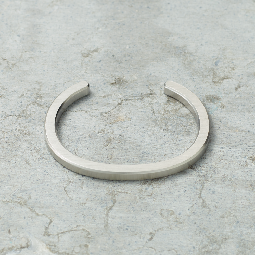 Silver bracelet on a textured gray surface
