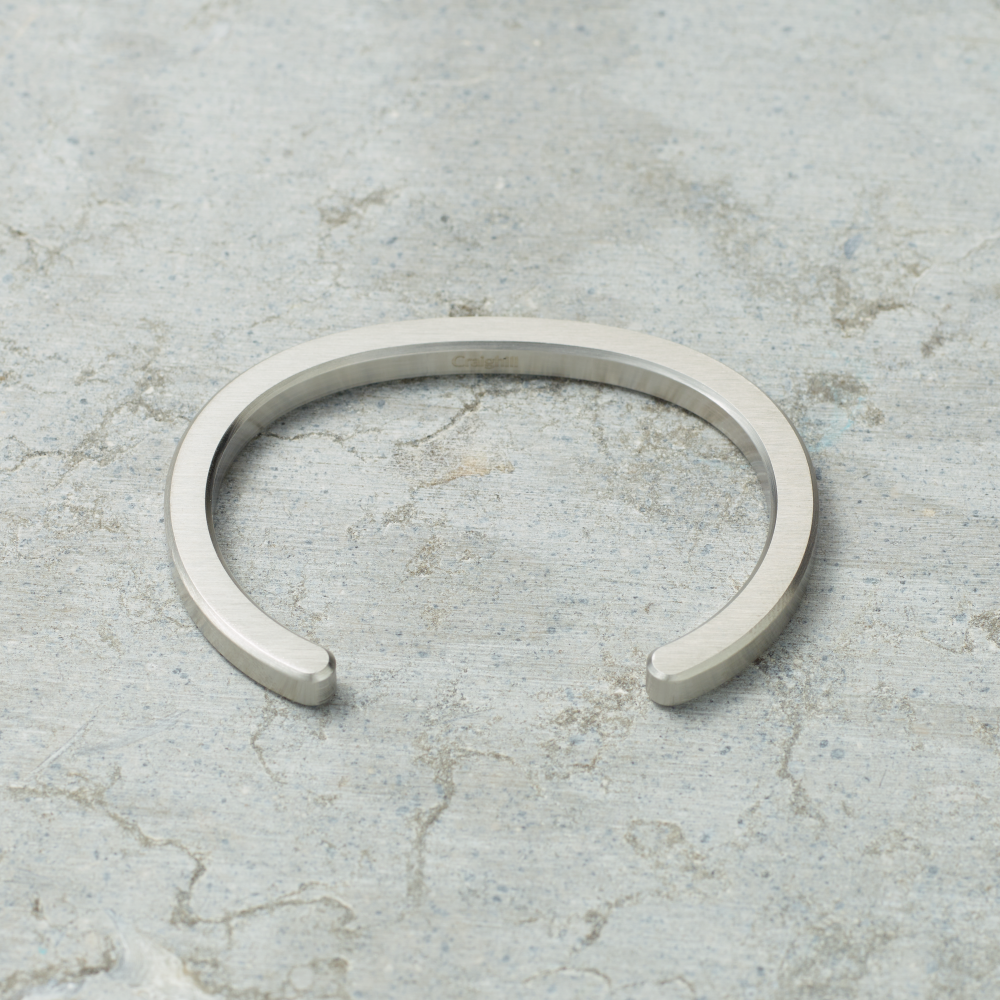 Silver bracelet on a textured gray surface
