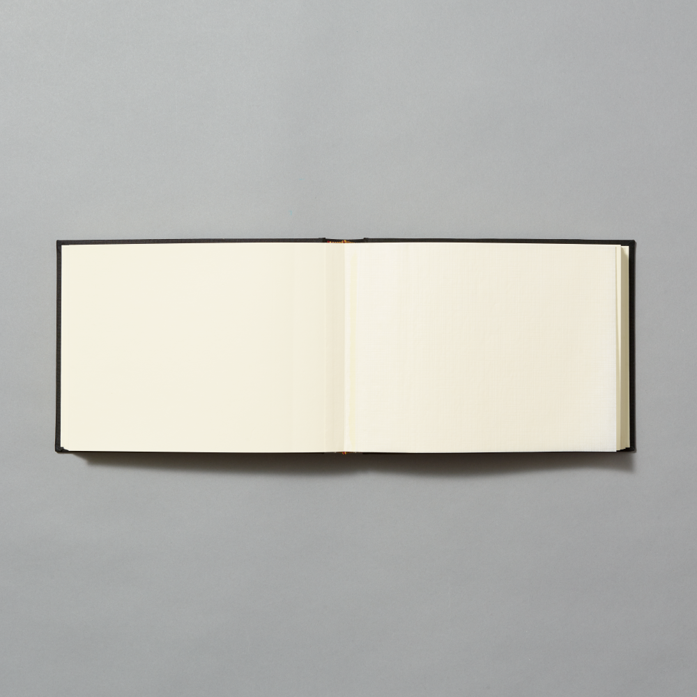 An open blank photo album with cream-colored pages displayed horizontally against a solid gray background.