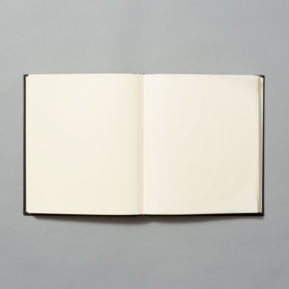 An open blank photo album with cream-colored pages and a black cover, shown flat against a solid gray background.