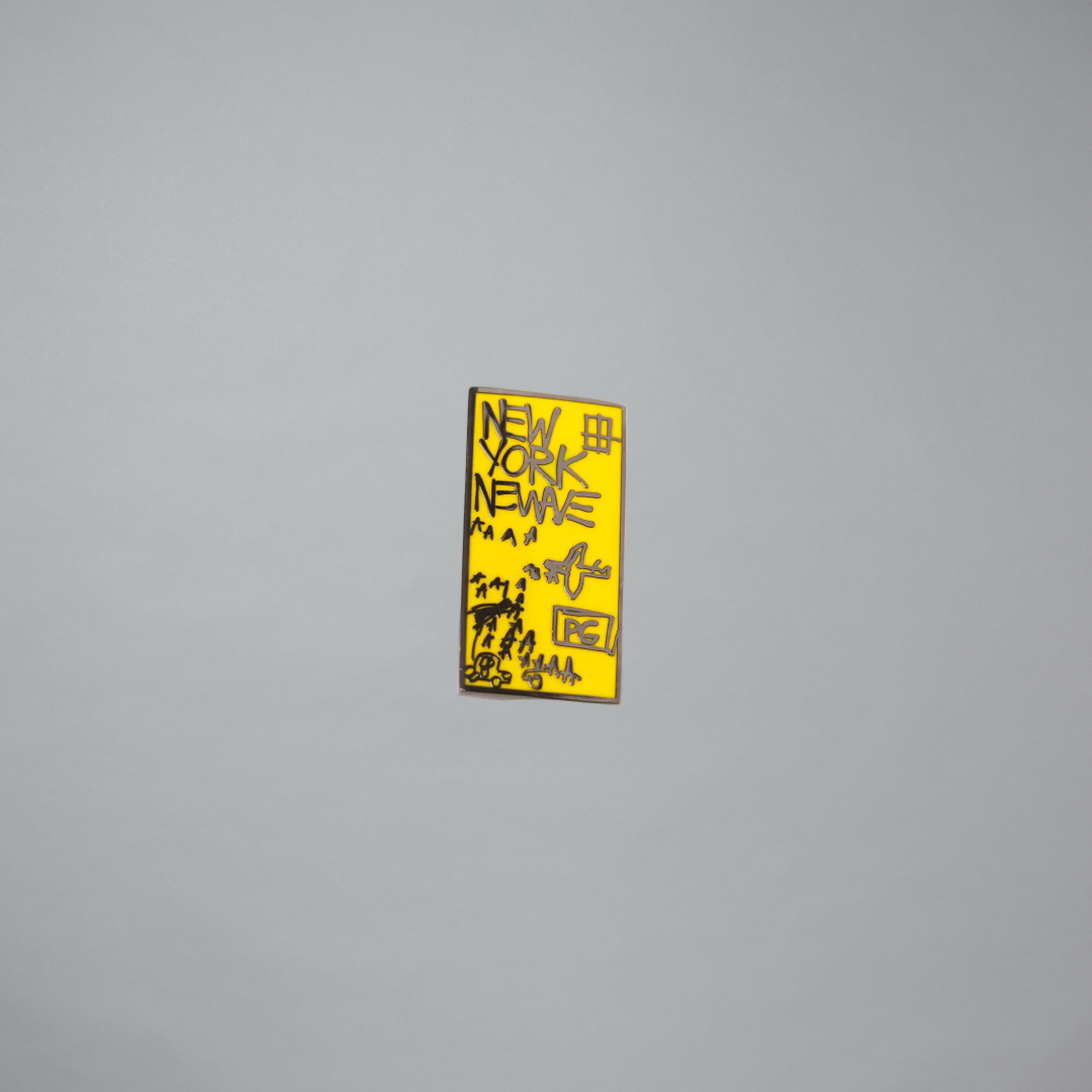 Yellow rectangular pin with black text on a gray background