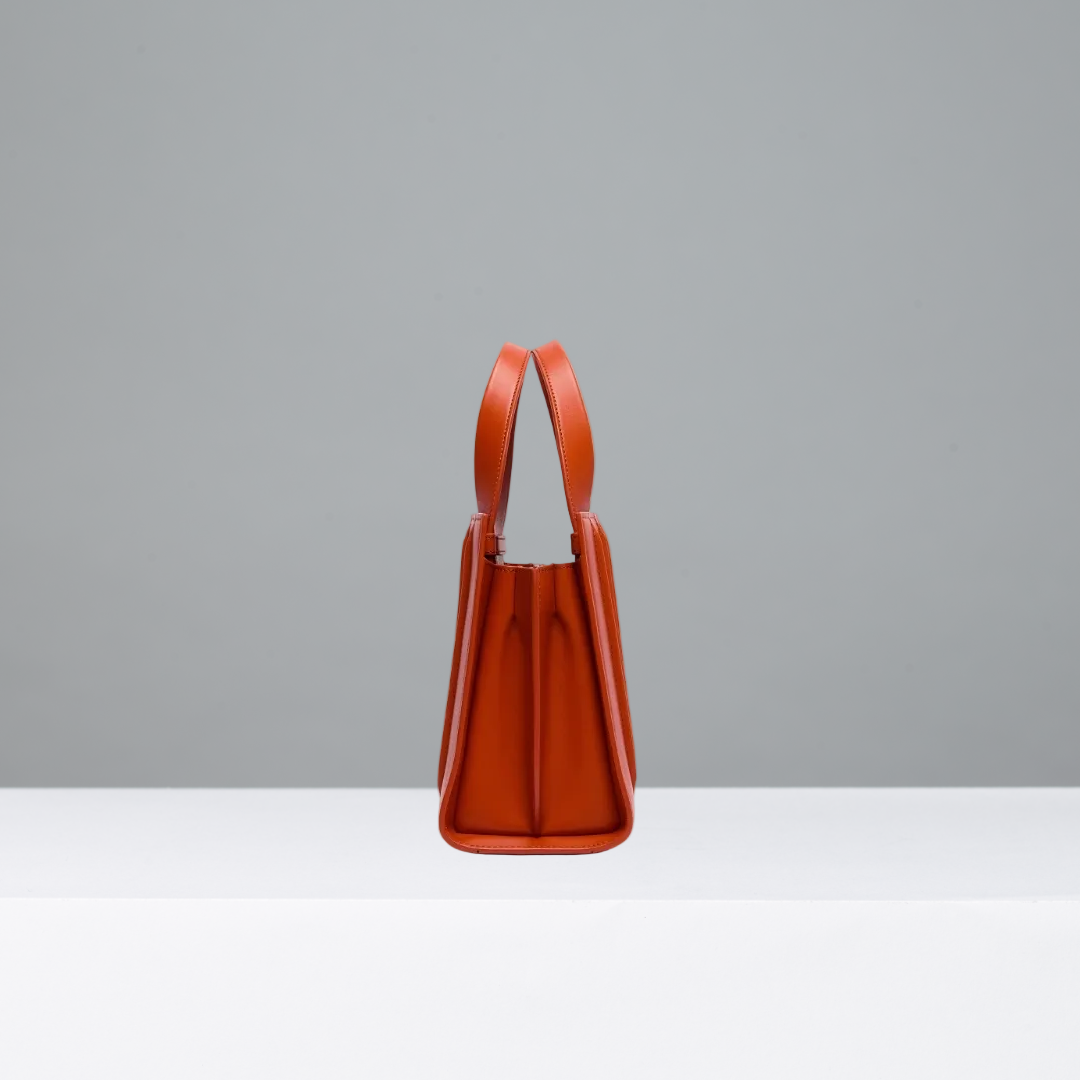 Orange handbag on a gray background