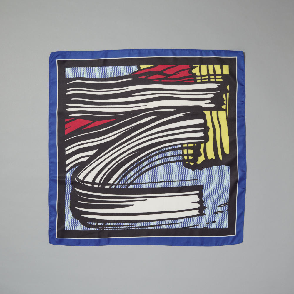 A square silk scarf with a vibrant graphic print of Roy Lichtenstein's work Little Big Painting displayed flat against a neutral gray background