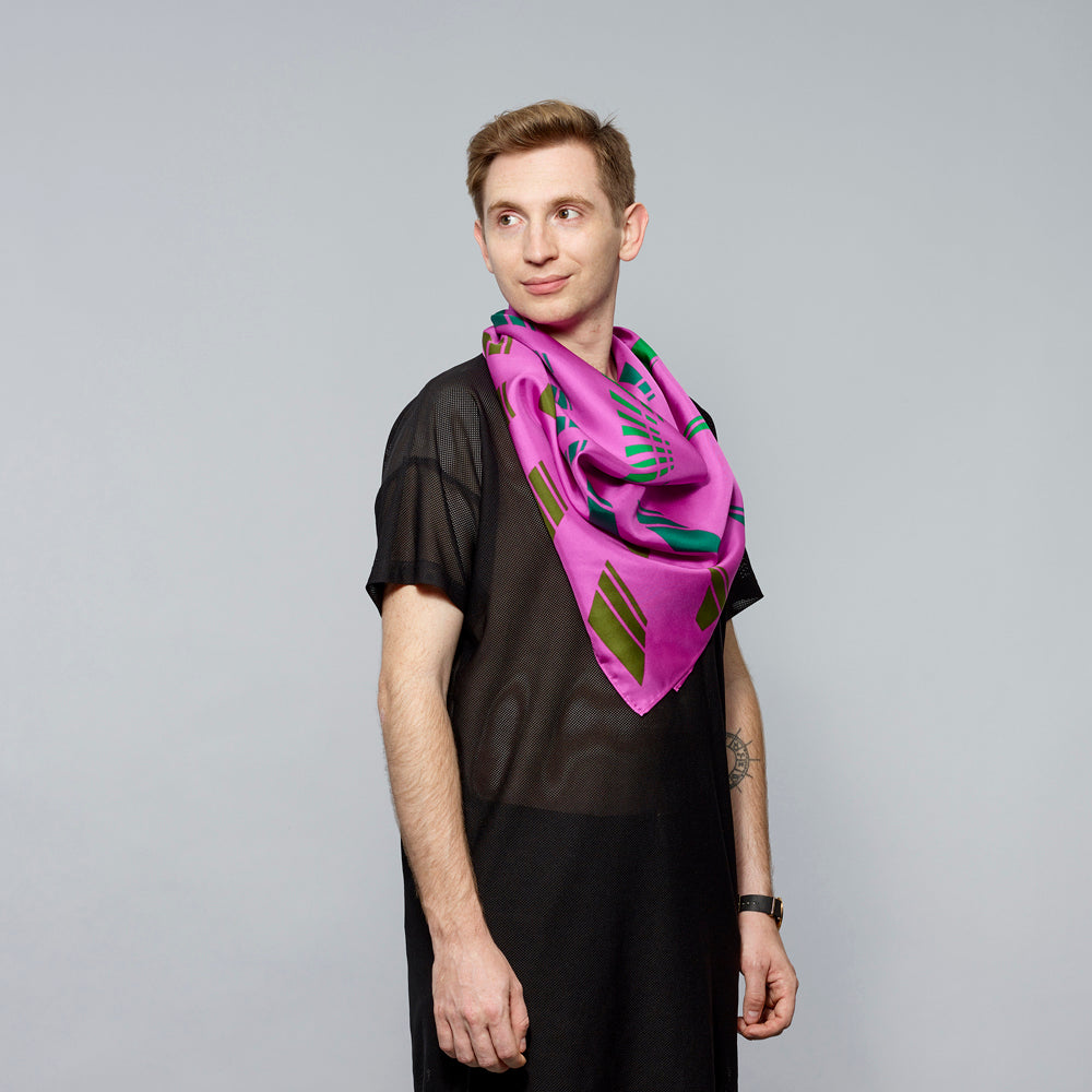 Model wearing 100% silk twill magenta with green corridor scarf by Carol Bove. Measures 36" x 36"