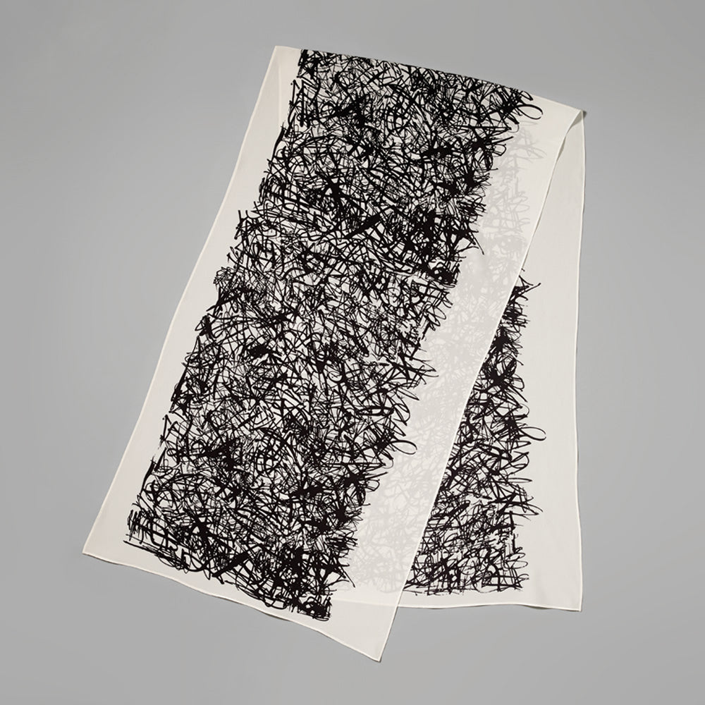 100% silk crepe de chine scribbles scarf by Carol Bove. Measures 20.87" x 74.41"