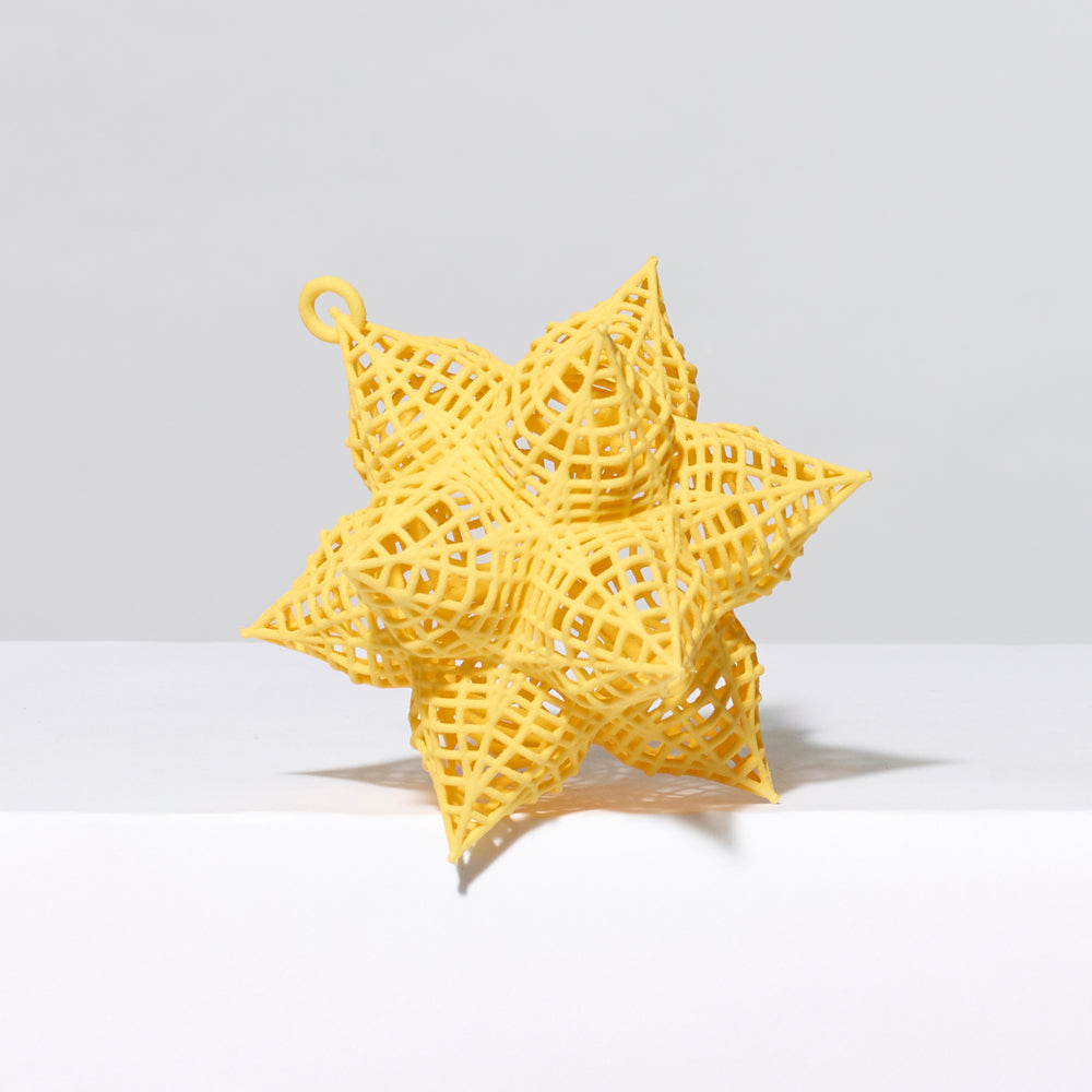 3-D printed plastic Frank Stella star ornament in yellow. Measures approximately 4" x 4" x 4"