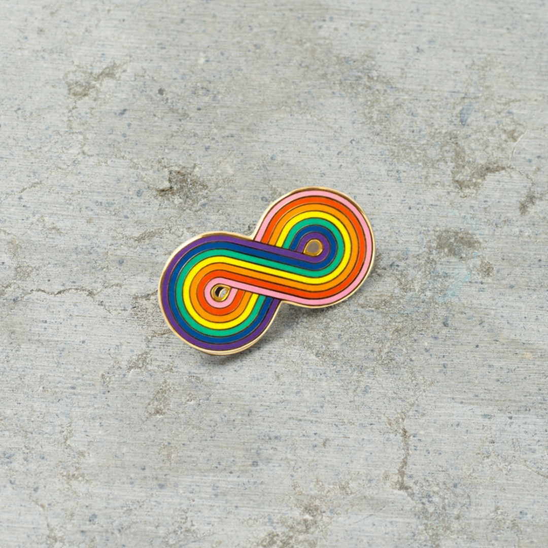 1.25" Hard enamel "Forever Gay" pin on a gray background