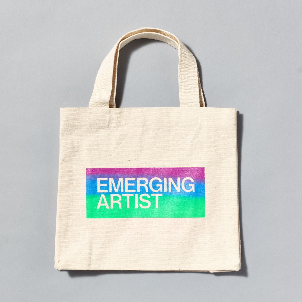 100% cotton tote bag that reads "Emerging Artist" on the front, sized 8.75" x 10.75"