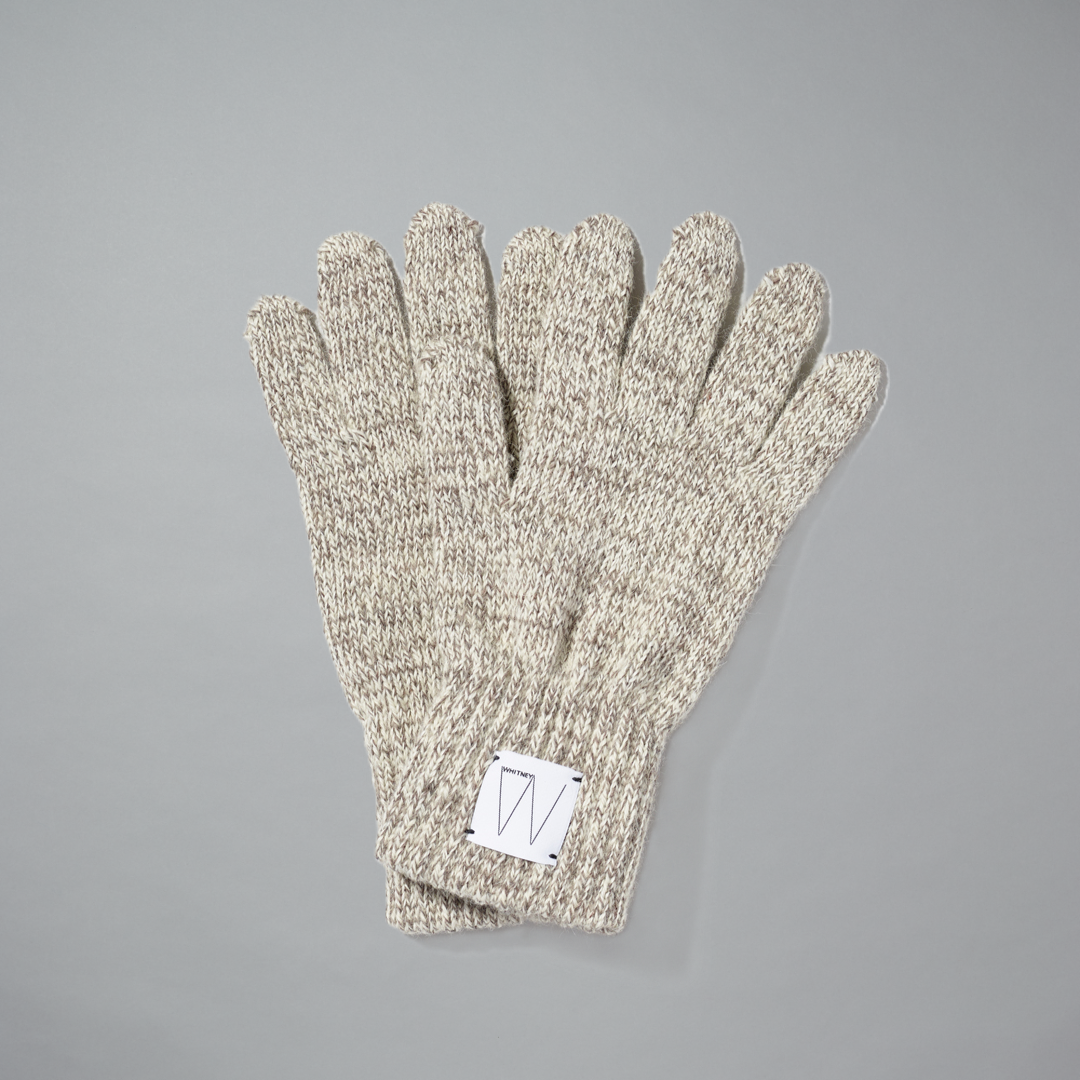Oatmeal wool gloves with a white Whitney logo on a gray background