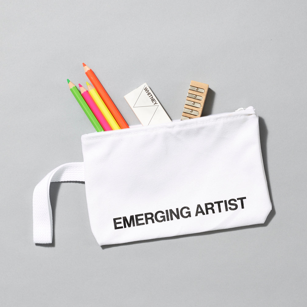 100% Cotton white pouch with handle with text that reads "Emerging Artist", containing colored pencils, eraser, and pencil sharpener. Measurements are 10.5" x 7" with a 6" handle.
