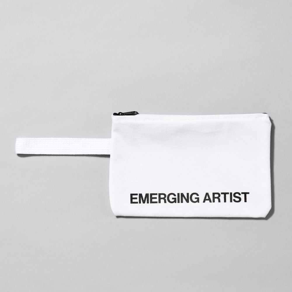 100% Cotton white pouch with handle with text that reads "Emerging Artist". Measurements are 10.5" x 7" with a 6" handle.