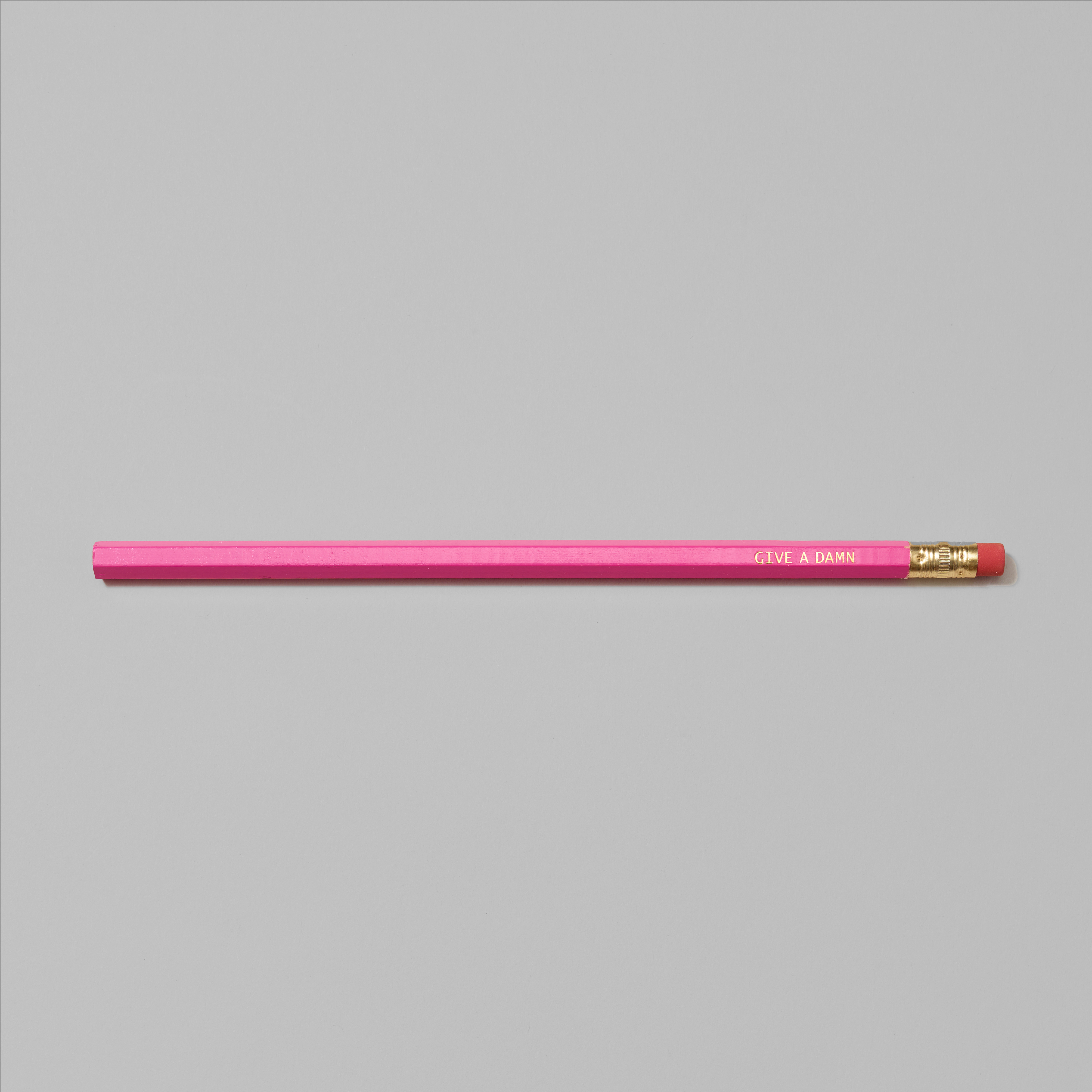 Pink pencil with Give A Damn in gold foil text