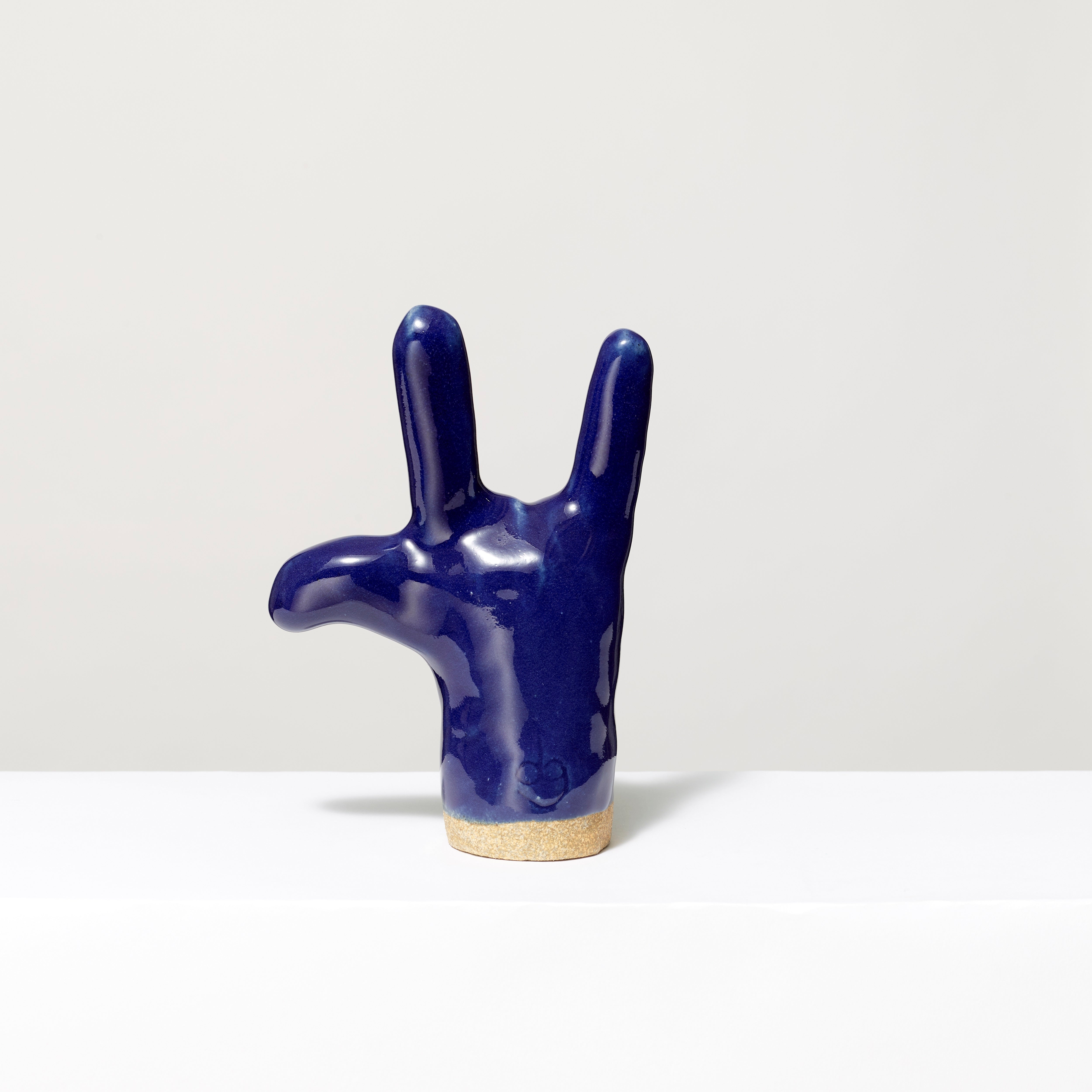 100% Ceramic love sign hand sculpture. Measures 7" x 5" x 3". 