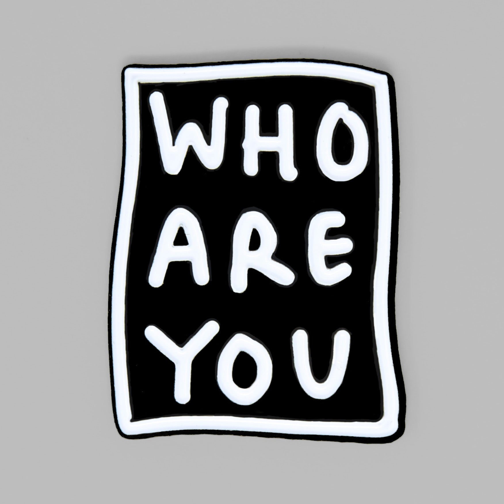 Black and white enamel pin featuring WHO ARE YOU by Shantell Martin