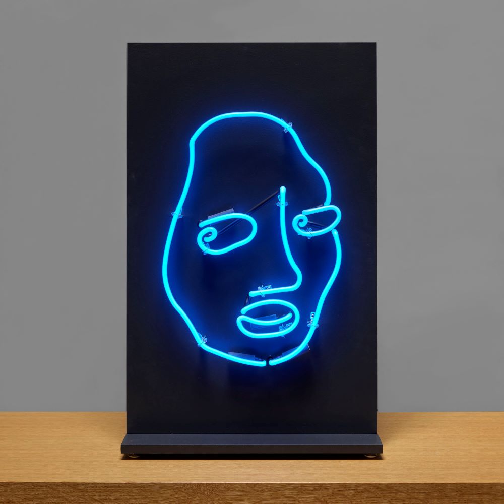 10mm lite blue neon edition of Shantell Martin's DRINK WELL in black on tabletop. Measures 14" W x 20" H.