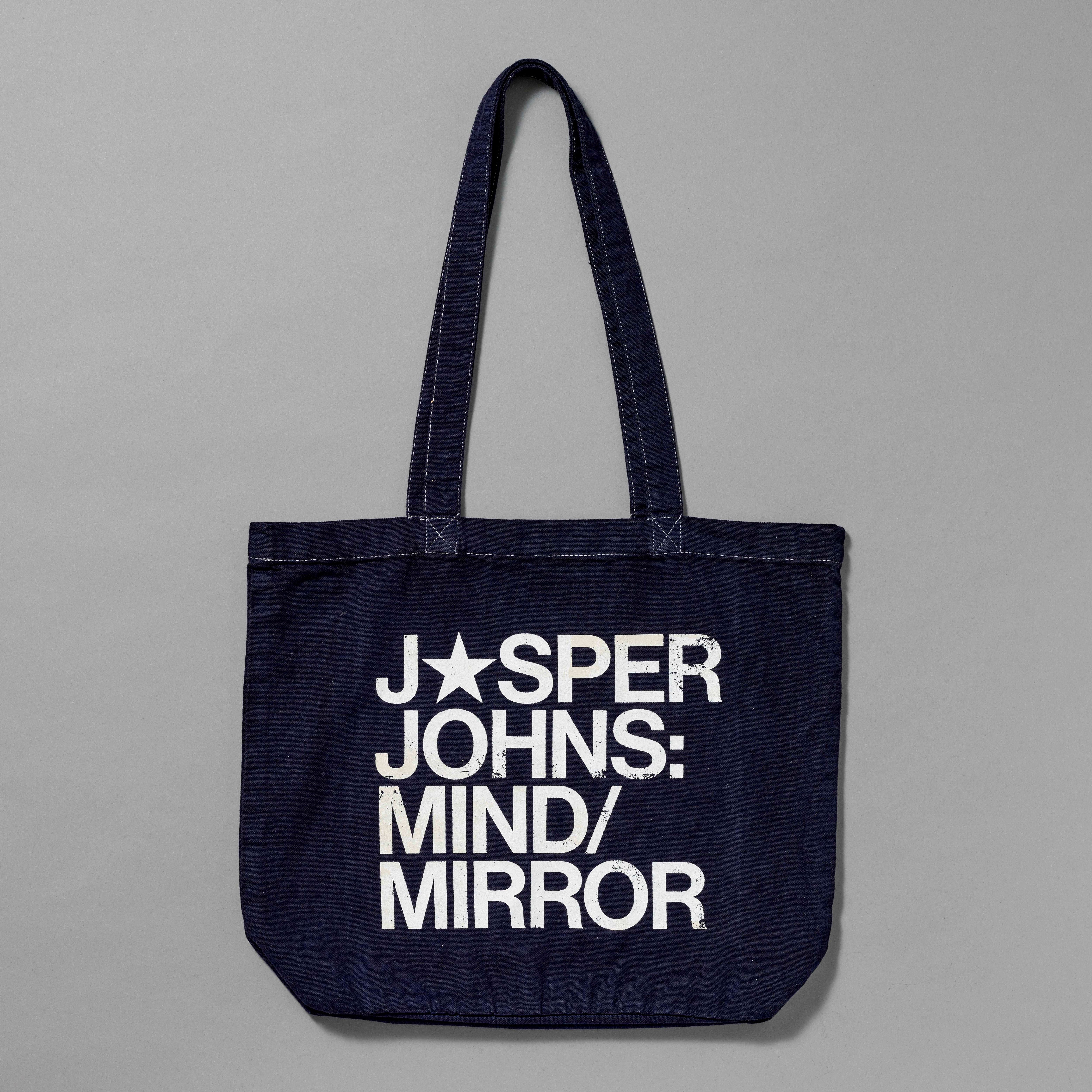 100% Organic Cotton navy tote with Jasper Johns: Mind/Mirror printed in white. Measures 15.5" x 13". 11.5" handles