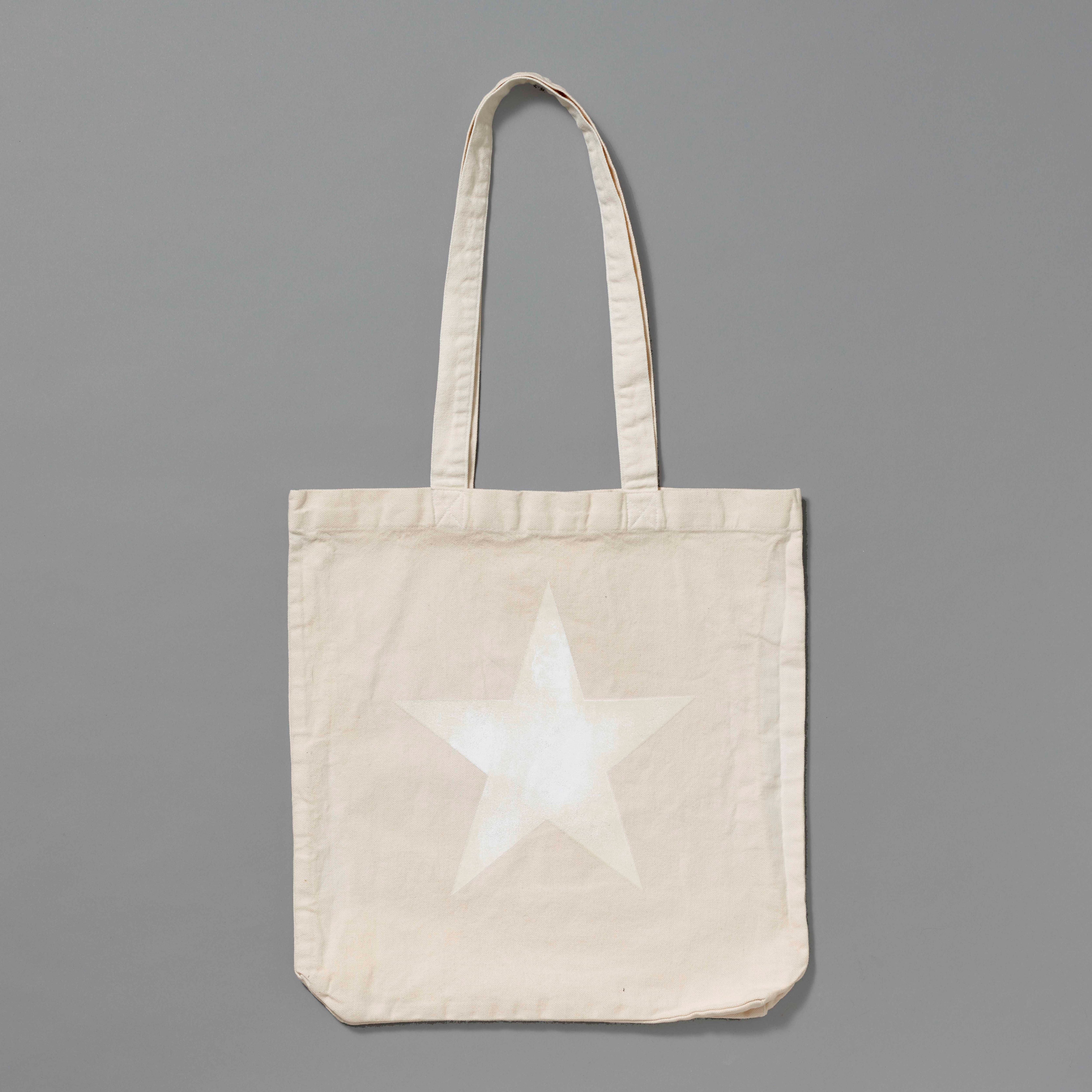 100% Organic Cotton cream tote with white star printed. Measures 15.5" x 13". 11.5" handles