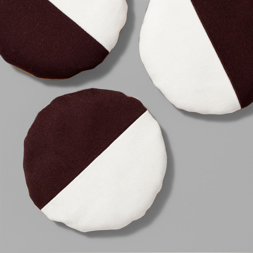 Selection of cotton fabric and sand filled black and white cookies with a 4" diameter