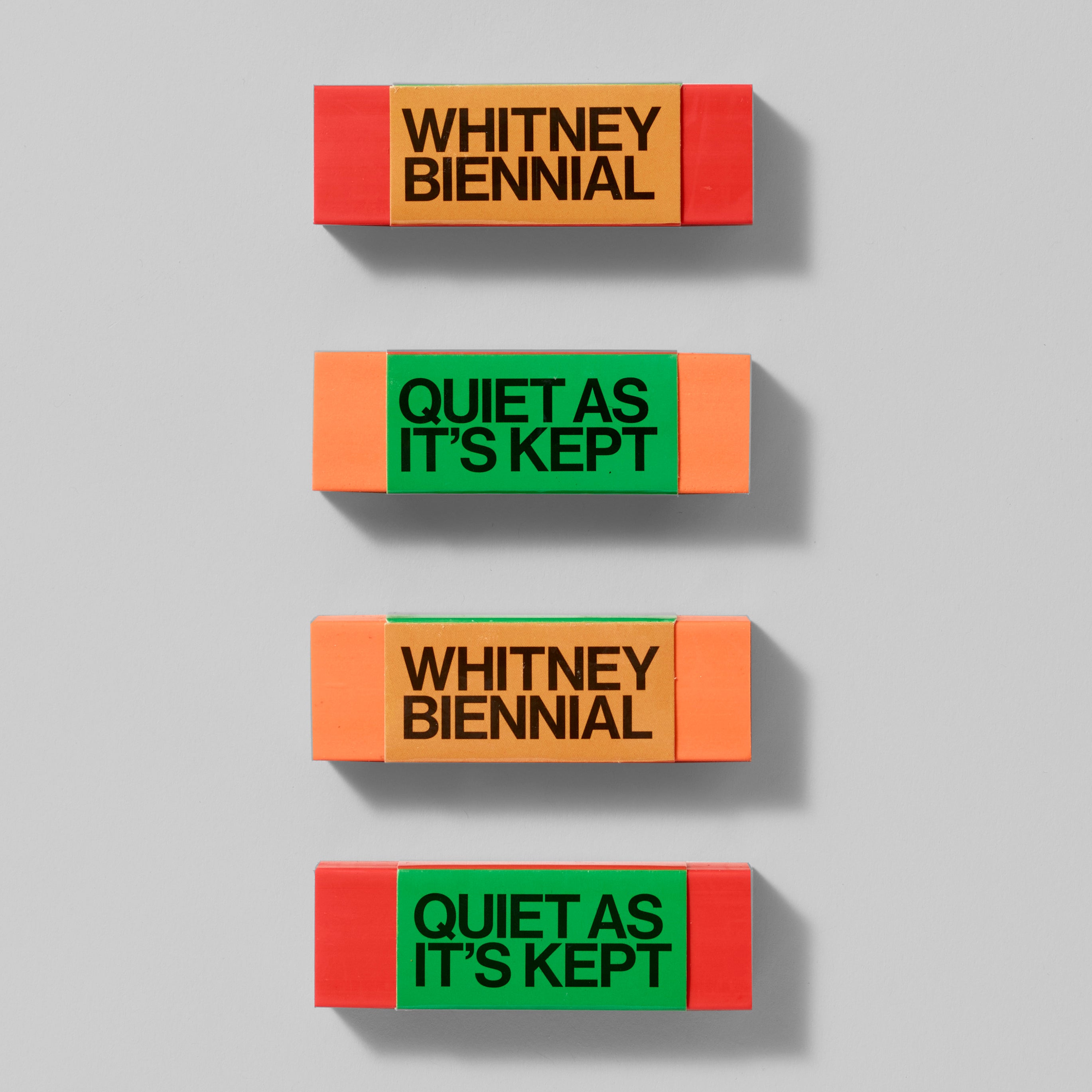 2.75" x 1" red and orange erasers from the Whitney Biennial
