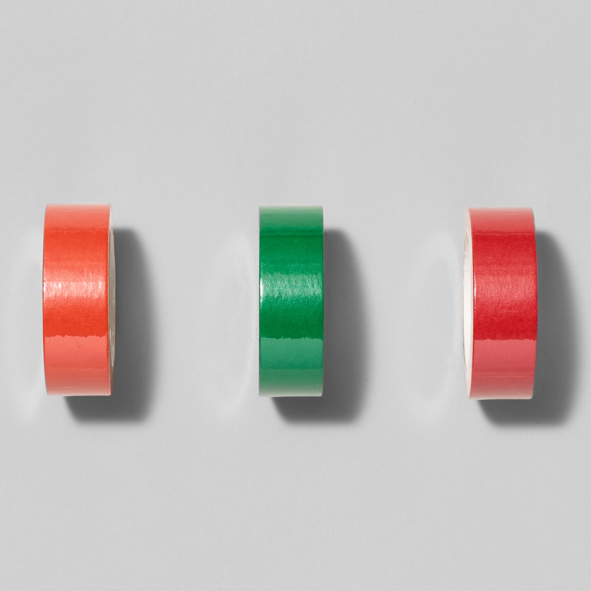 Assortment of Biennial Washi Tape in Orange, Green, and Red. Measures 1.75" in diameter