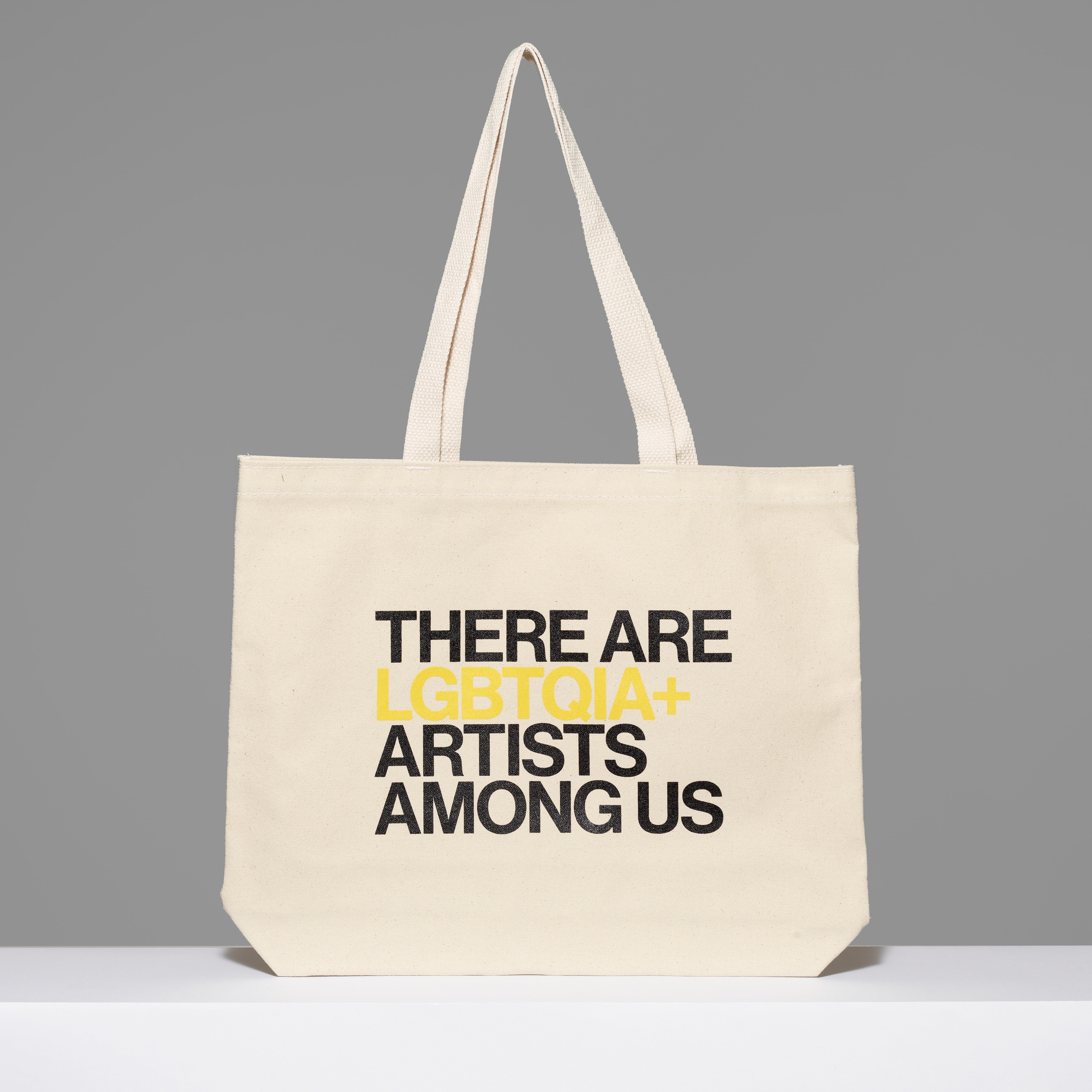 100% cotton There Are LGBTQIA+ Artists Among Us Tote with black and yellow text. Measures 18" x 14". 3.5" gusset, 11" handles.