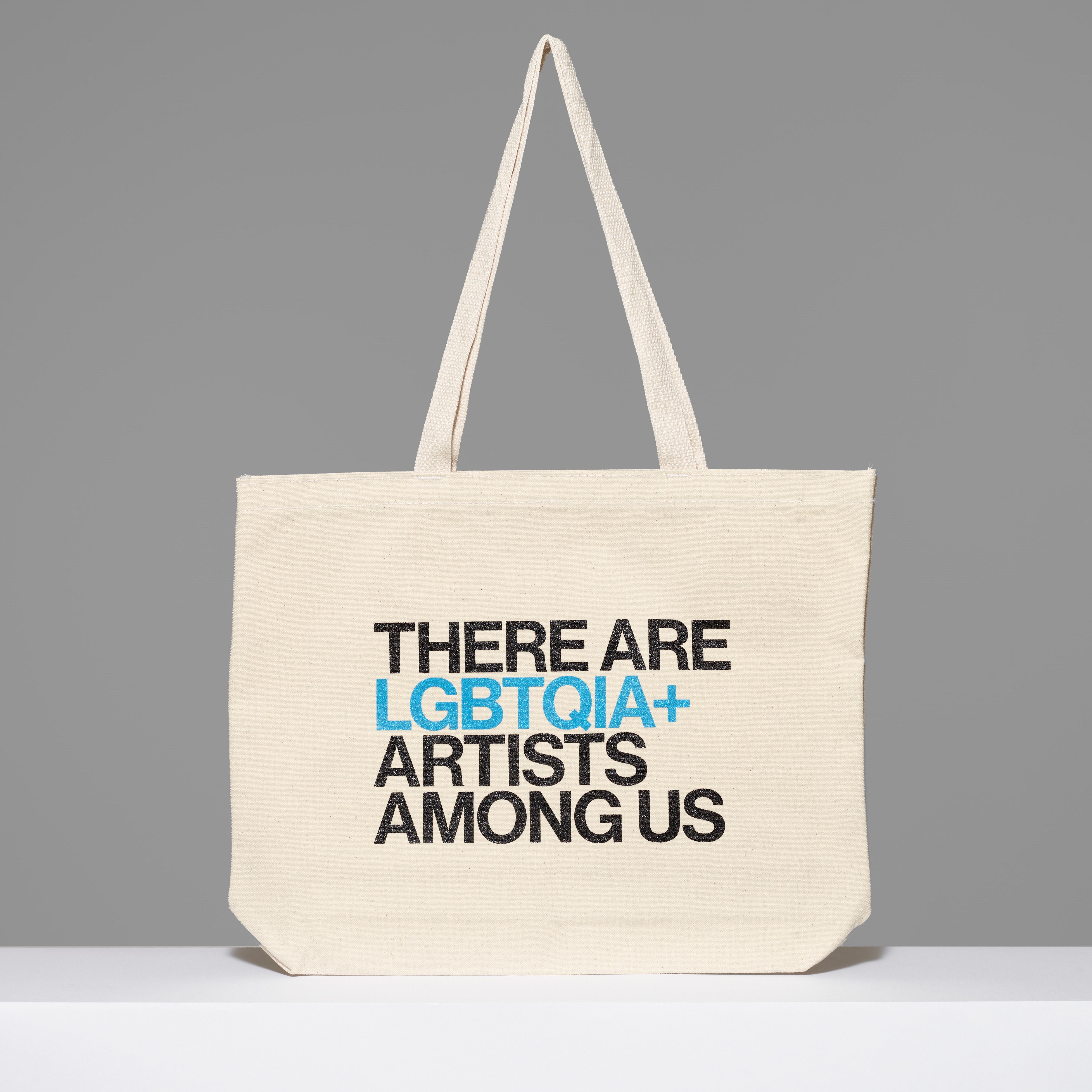 100% cotton There Are LGBTQIA+ Artists Among Us Tote with black and blue text. Measures 18" x 14". 3.5" gusset, 11" handles.
