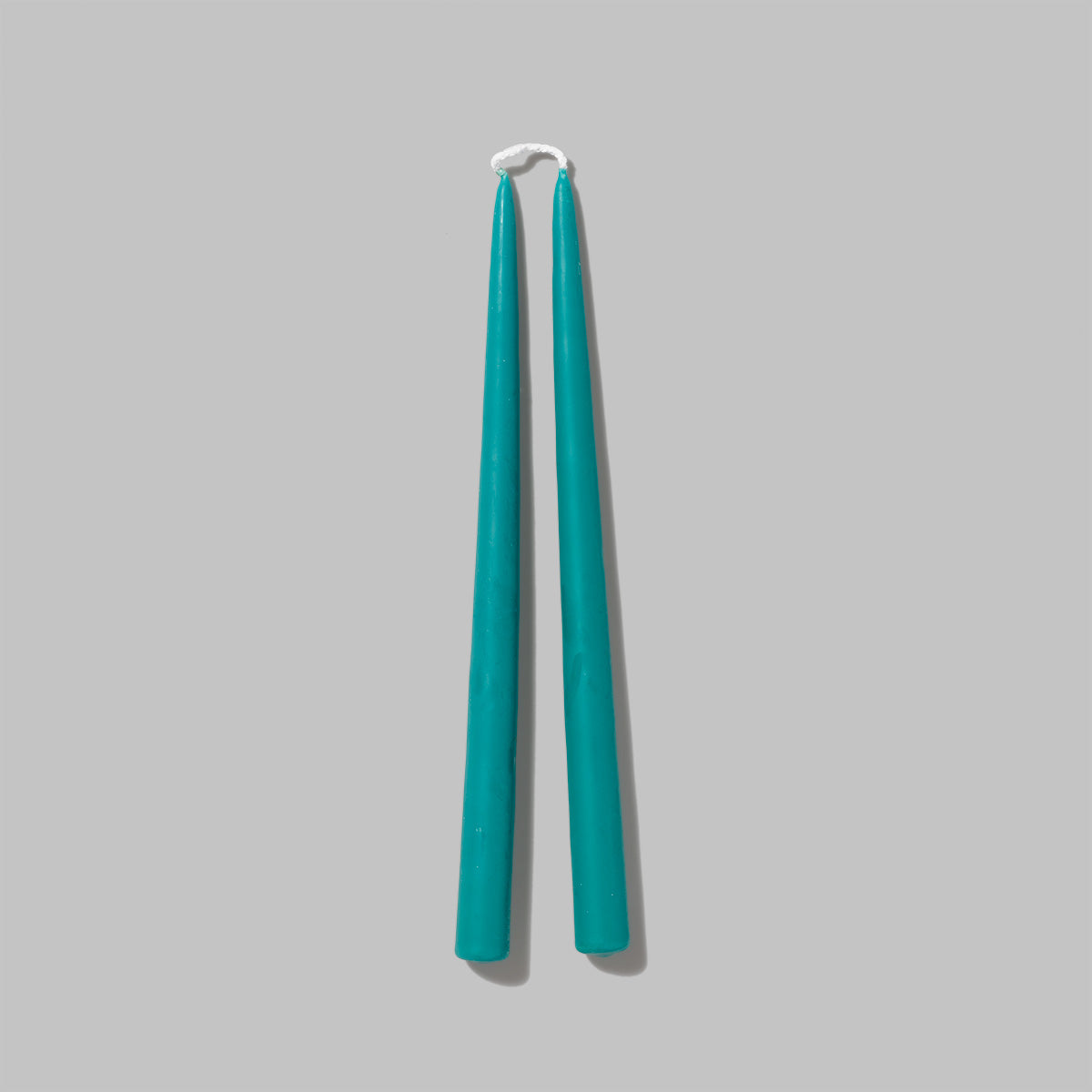 Set of teal Beeswax pillar candles. Measures 0.8 in diameter x 11.5 in tall