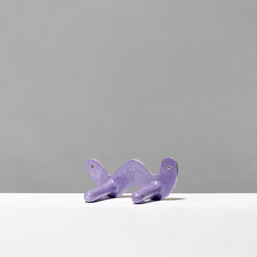 Hand built ceramic purple biennial wiggle 2 wall hook. Measures 2.25" tall x 7.25" wide